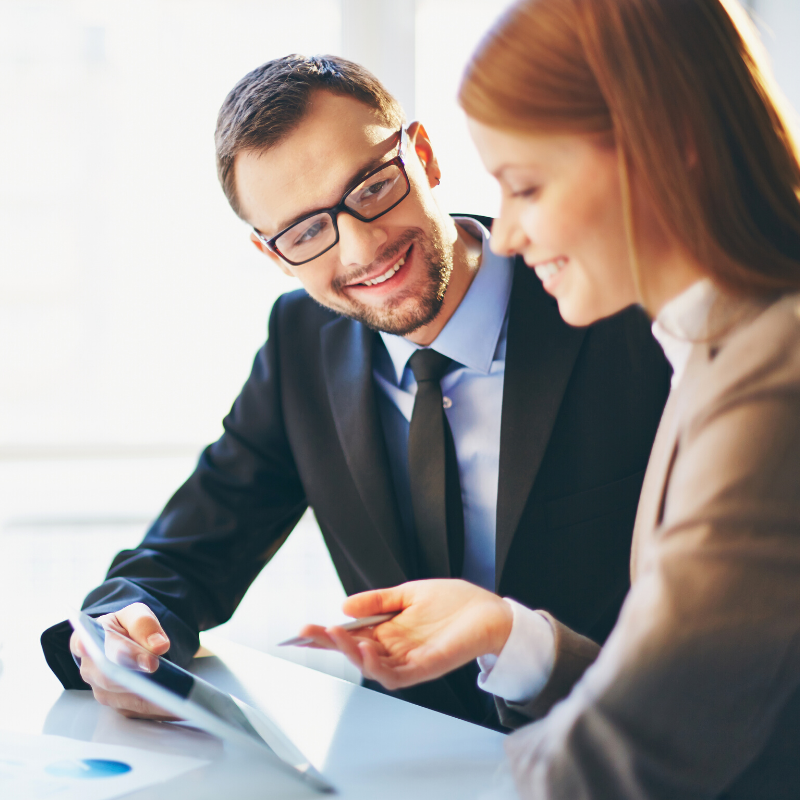Photo of man and women looking at tablet