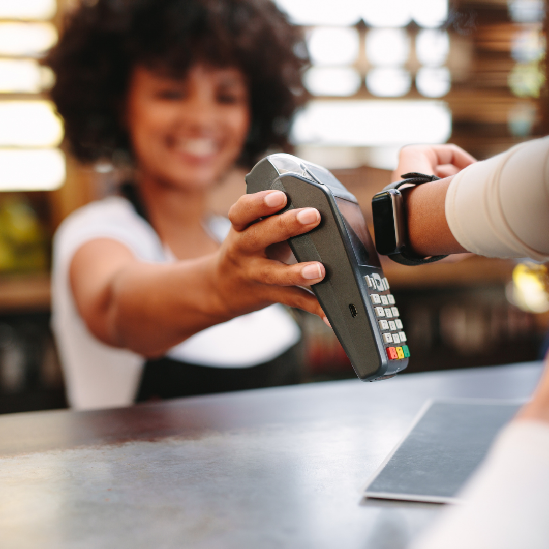 Photo of person paying with an Apple Watch
